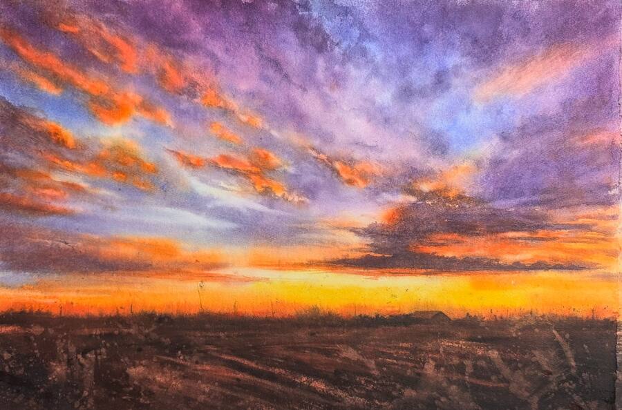 Solnedgång i vibrerande färger i orange, violett, rött och guld